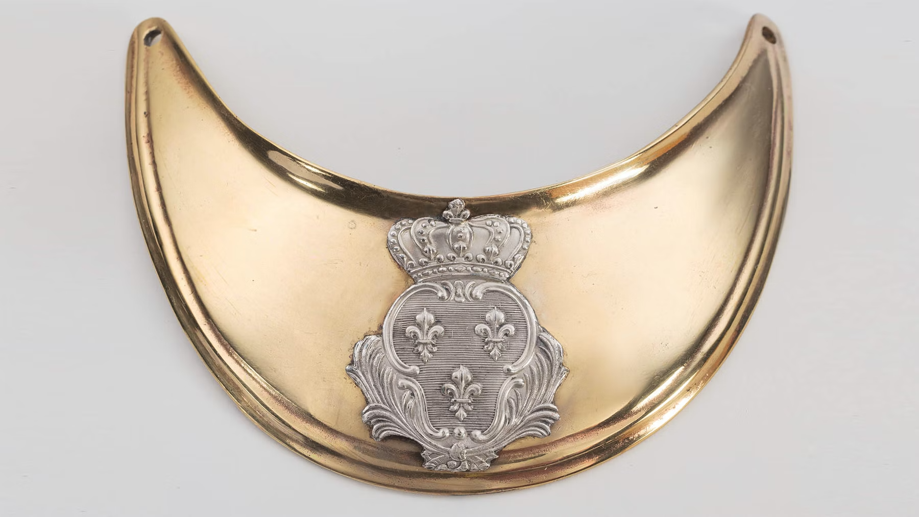 French officers wore a gorget like this one around their neck, as a symbol of their rank.